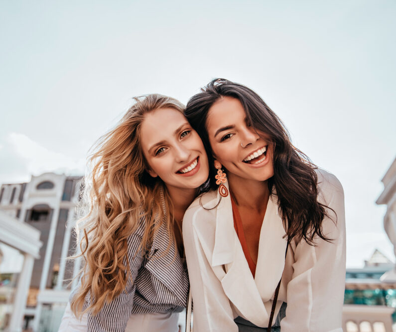 women happy with the high quality dental results of teeth whitening